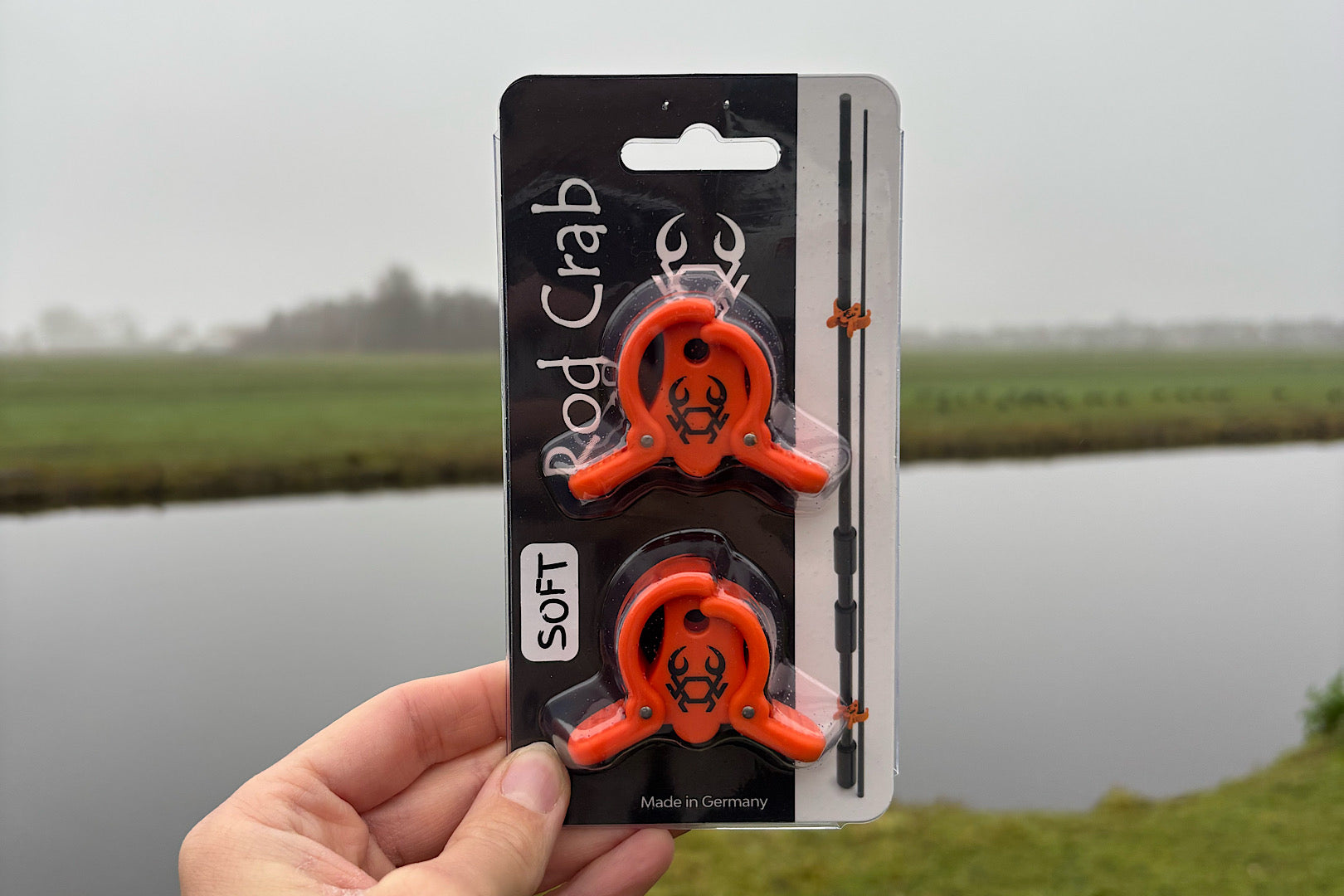 Rod Crab multi-piece fishing rod clamp with spring hinge and lure hook loop for secure transport and storage