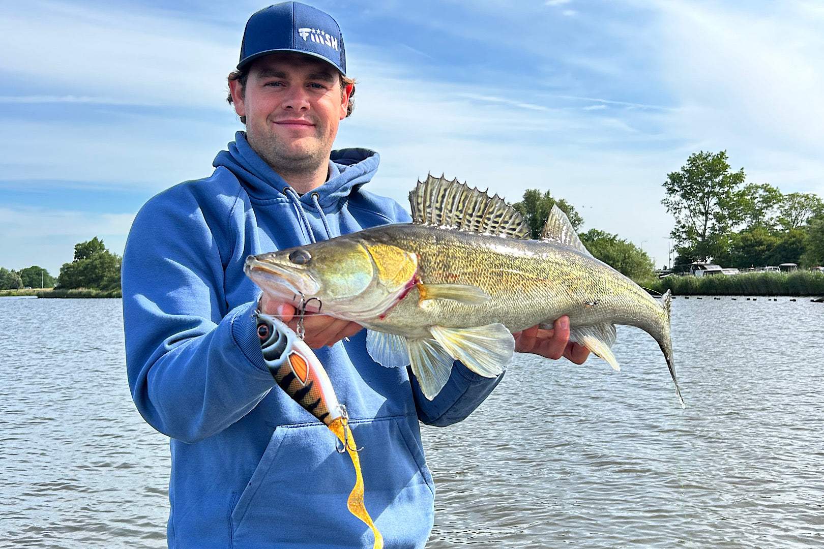 Strike Pro Guppie fishing lure with compact design and interchangeable tail options for trophy fish