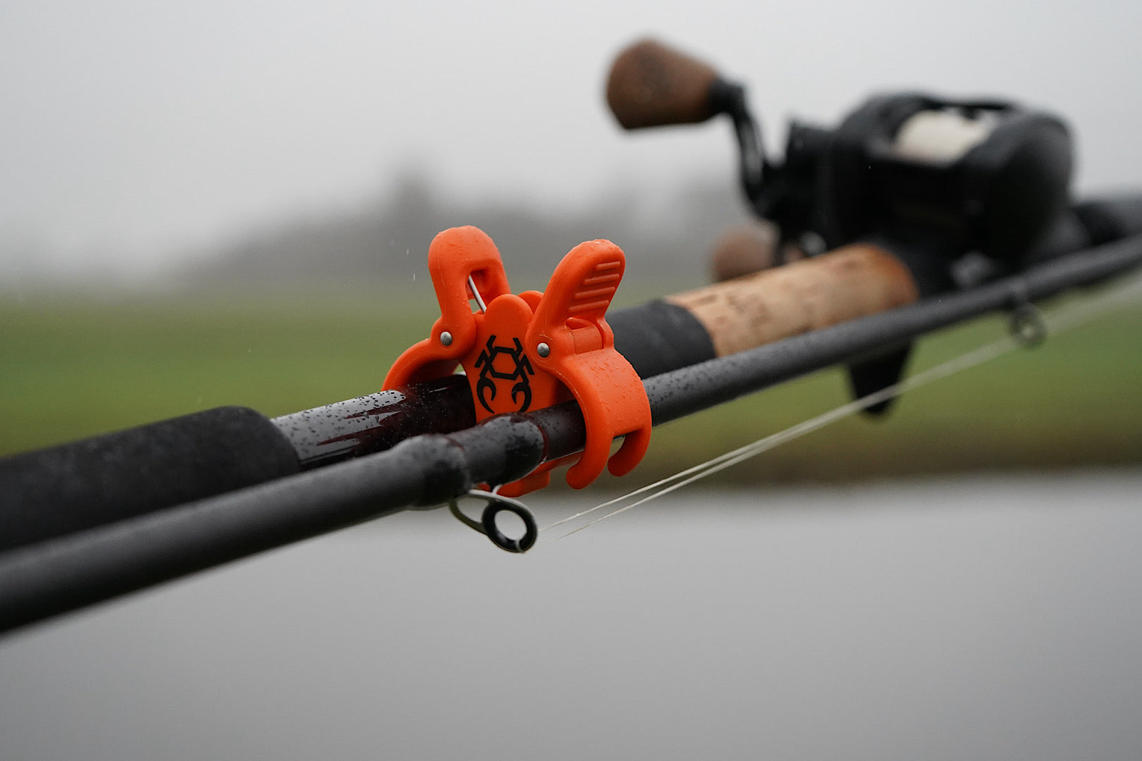 Rod Crab multi-piece fishing rod clamp with spring hinge and hook loop for secure transport and protection