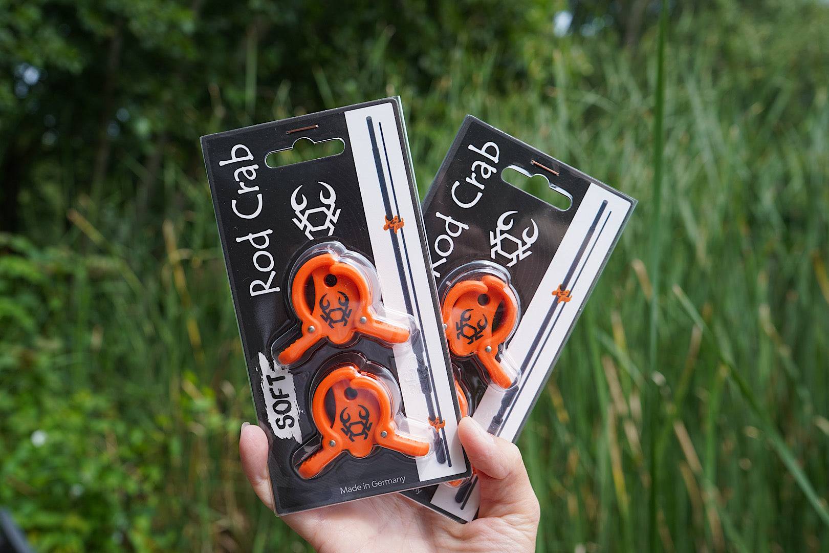 Compact Rod Crab fishing rod clamp with spring hinge securing multi-piece rods and lure loop