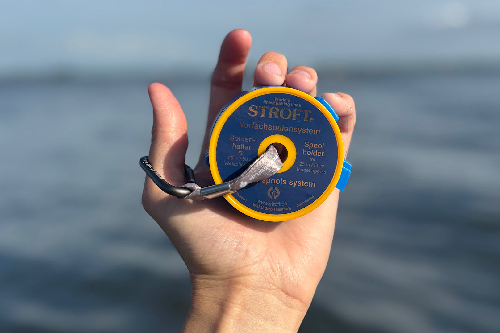 Stroft Leader Spool System with cutter rings and strap holding multiple fishing leader spools organized
